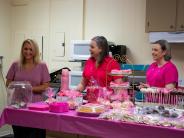 Happy people in front of pastry covered table